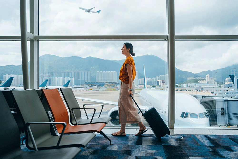 Woman with luggage at airport.