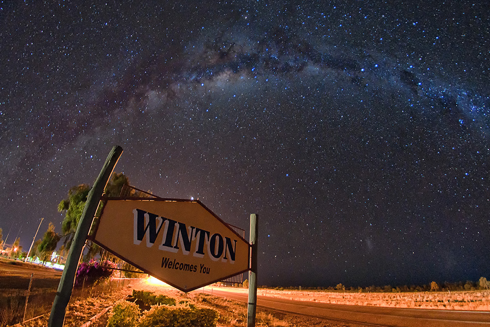 Welcome to Winton sign under a night sky.