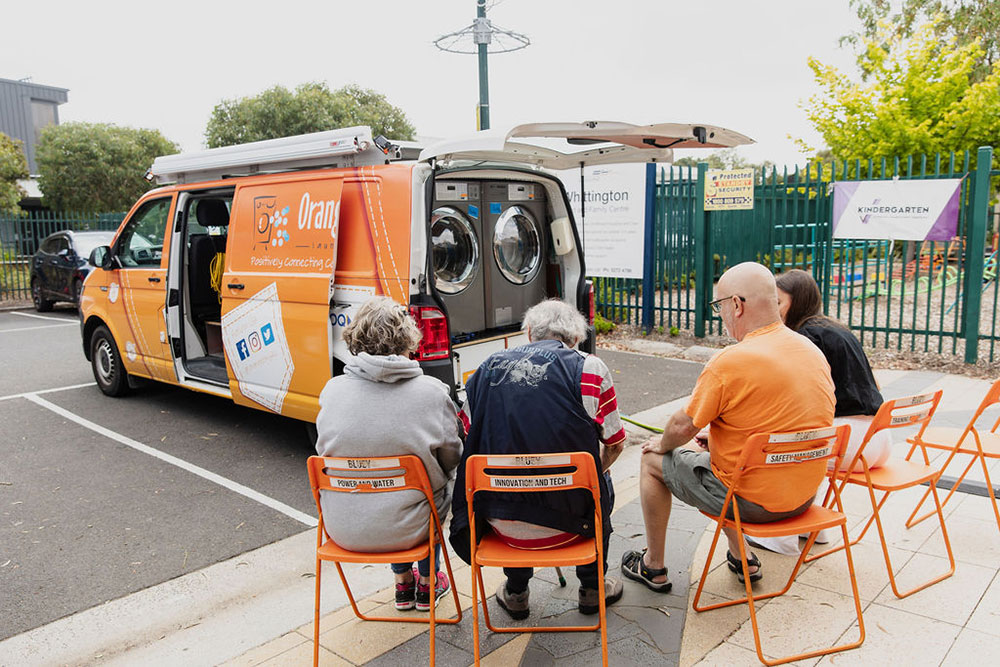 Orange Sky van and 'friends' chatting with volunteers.