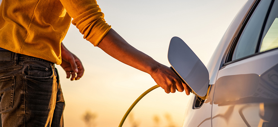 Man charging electric vehicle