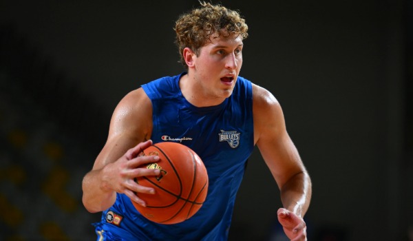 Brisbane Bullets player dribbling basketball wearing team jersey