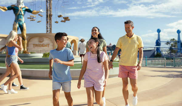village roadshow family walking with smiles on their faces fun