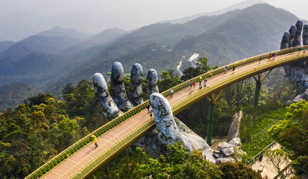 Vietnam grasslands and hand statue with people
